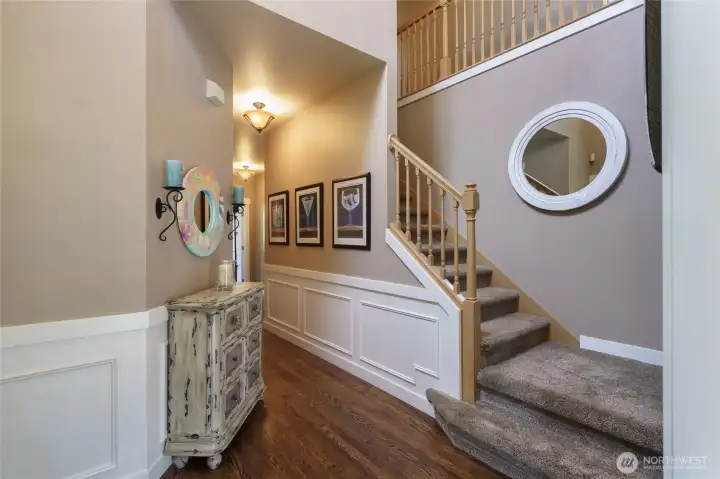 Front entry showcasing the stairs to the second floor. Formal living room is on the right and hallway to half bath, office, garage and family room is on the left. Front entry showcasing the stairs to the second floor. Formal living room is on the right and hallway to half bath, office, garage and family room is on the left.