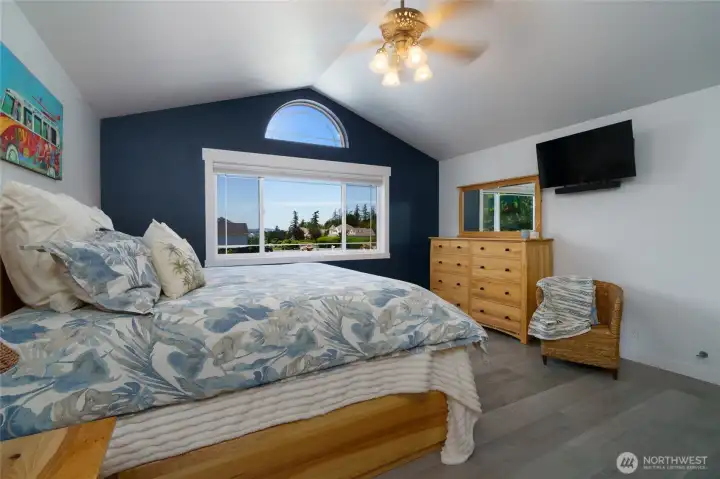 Upstairs primary bedroom features a partial view of Padilla Bay. New LVP flooring installed in primary bedroom and bathroom in 2019. Upstairs primary bedroom features a partial view of Padilla Bay. New LVP flooring installed in primary bedroom and bathroom in 2019.