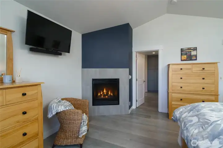 Primary bedroom with propane fireplace and access to the primary bath. Primary bedroom with propane fireplace and access to the primary bath.