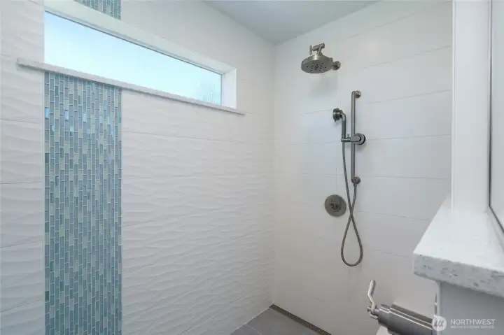 Custom walk in shower in primary bathroom. Custom walk in shower in primary bathroom.