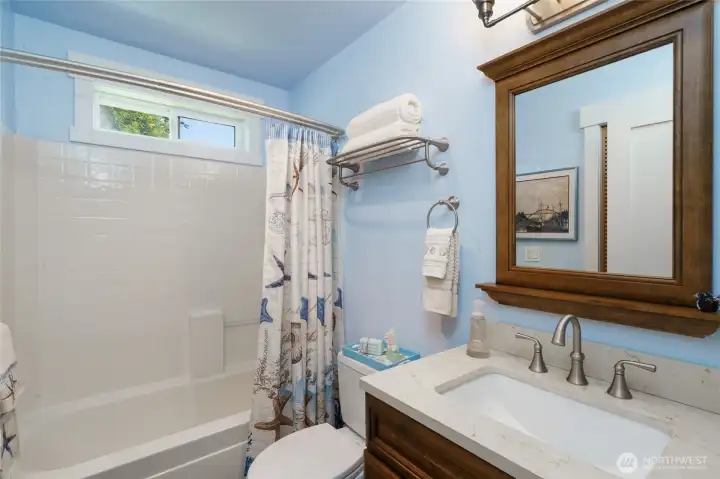 Upstairs hallway full bath refreshed in 2017 with quartz countertops, toilet, light fixtures and tile floor. Upstairs hallway full bath refreshed in 2017 with quartz countertops, toilet, light fixtures and tile floor.