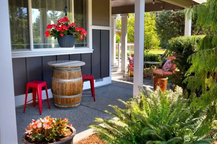 Another view of the covered front porch leading to the side deck. Water feature located off the deck provides a soothing sound as one enjoys the expansive yard. Another view of the covered front porch leading to the side deck. Water feature located off the deck provides a soothing sound as one enjoys the expansive yard.