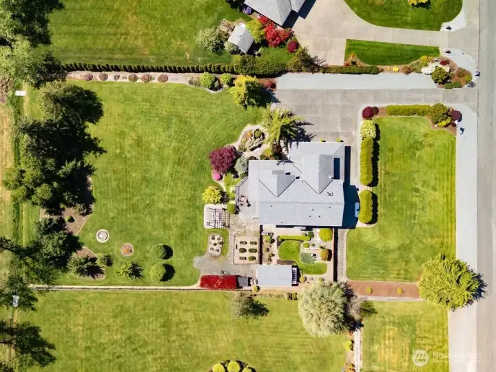 Over head view of the shy 1 acre property with gazebo, raised garden beds, firepit and small fenced in yard area for children or pets. Lawmower garage is located at the back of the fenced in area and was painted in 2025 with new roof in 2021. Architectural comp roof was installed on the main home in 2021 as well. Over head view of the shy 1 acre property with gazebo, raised garden beds, firepit and small fenced in yard area for children or pets. Lawmower garage is located at the back of the fenced in area and was painted in 2025 with new roof in 2021. Architectural comp roof was installed on the main home in 2021 as well.