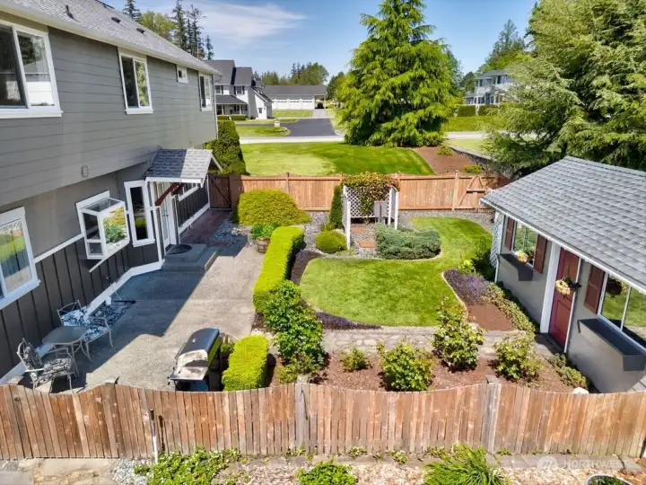 Fenced yard area off the back door and patio. Lawmower garage is small building in the back. Fenced yard area off the back door and patio. Lawmower garage is small building in the back.
