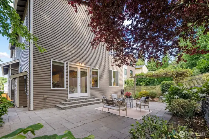 The fully paved backyard offers a low-maintenance outdoor retreat, perfect for relaxing with family or entertaining friends.