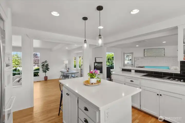Center island with room for seating and pendent lighting. Kitchen opens to large dining room and sunken living room! Center island with room for seating and pendent lighting. Kitchen opens to large dining room and sunken living room!