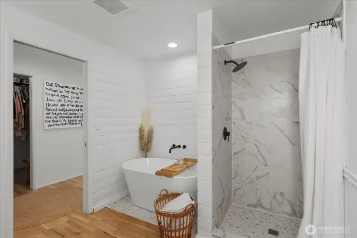Newly updated primary bathroom with freestanding soaking tub and walk-in shower. Newly updated primary bathroom with freestanding soaking tub and walk-in shower.