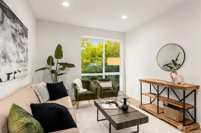 An ideal spot for morning coffee, this living room offers a cozy feel with large windows that frame the greenery outside. It feels like a private retreat in the city!