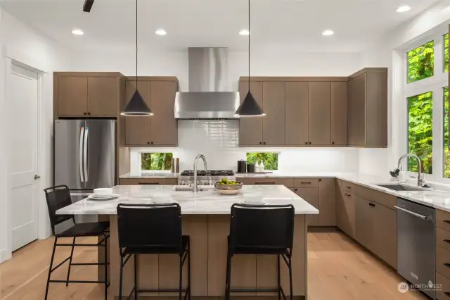 Custom solid cabinets, designer slab counters and wrap around breakfast bar