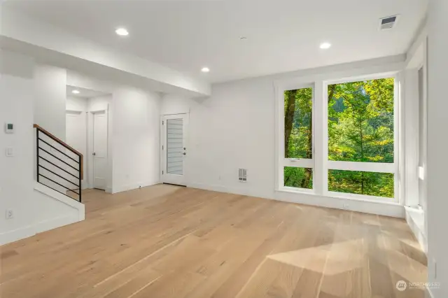 Lower level rec room walks out to back yard and features 9 foot ceilings and wide plank hardwood flooring