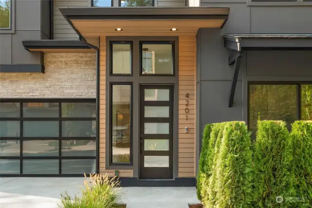 Covered porch features clear grain stained cedar siding and covered porch