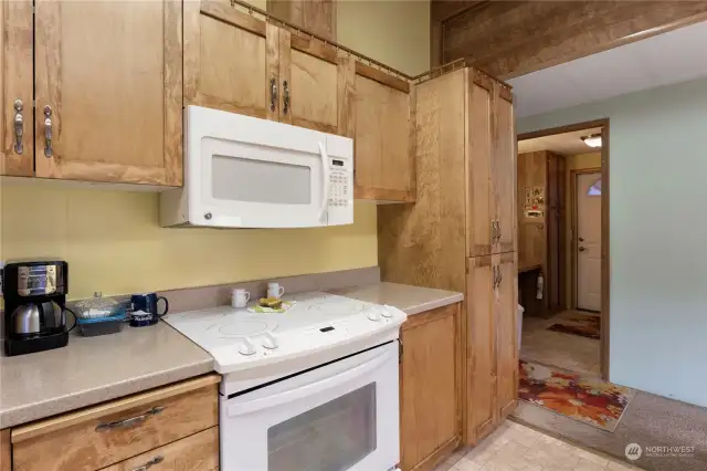 Across the hall from the gleaming kitchen is the utility room/mudroom. It's a roomy and convenient floorplan you'll love living in.