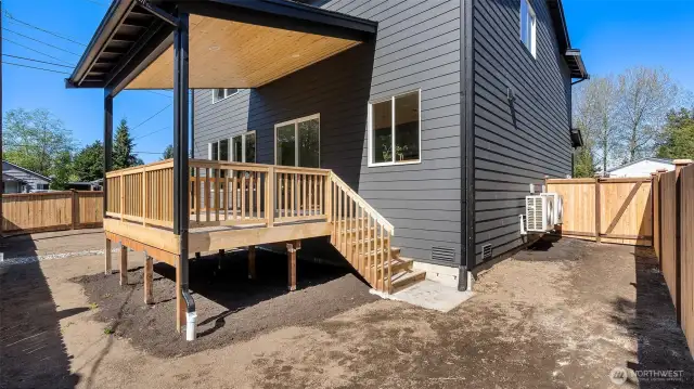 Spacious Fully fenced yard and covered deck with access stairs.