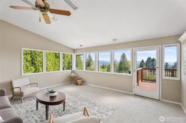 Main Level - Living Room filled with natural light from abundant windows, framing views of the countryside, Rainier Bridge, Columbia River, and breathtaking sunsets.