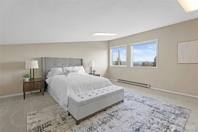 Upper Level – Bedroom showcasing sweeping views of the Columbia River, Rainier Bridge, stunning sunsets, and peaceful countryside!