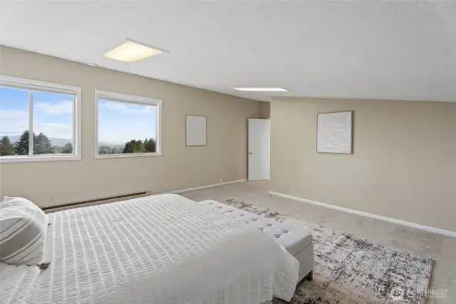Upper Level – Bedroom offering sweeping views of the Columbia River, Rainier Bridge, breathtaking sunsets, and serene countryside!