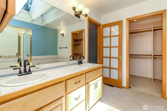 Primary bath with double vanities and spacious walk-in closet.