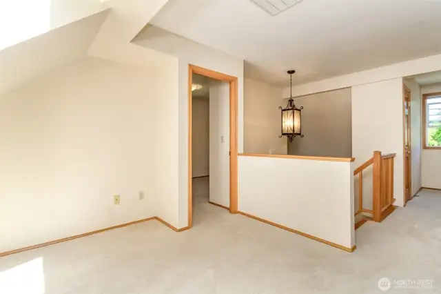 Nice space for your creativity at the top of the stairway landing area.
