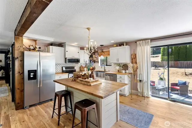 Bright and open kitchen - leads out to a large, level lot with multiple entertaining/relaxing areas.  Fully fenced too!