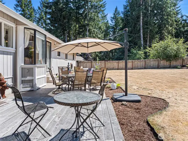 Large concrete patio with attached deck all set in a private, fully fenced - level yard
