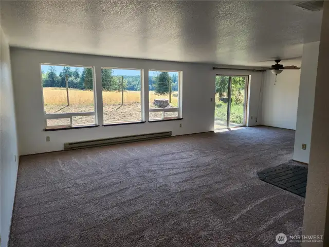 New paint inside the home brighten the spacious living area with wonderful windows allowing light and territorial views.  Sliding door to the right of photo.
