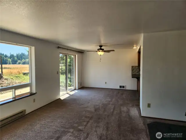 Dining area with the kitchen to the right of the photo.