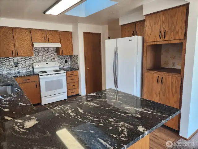 Beautiful tiled backsplash and built-in space for a good-sized microwave.