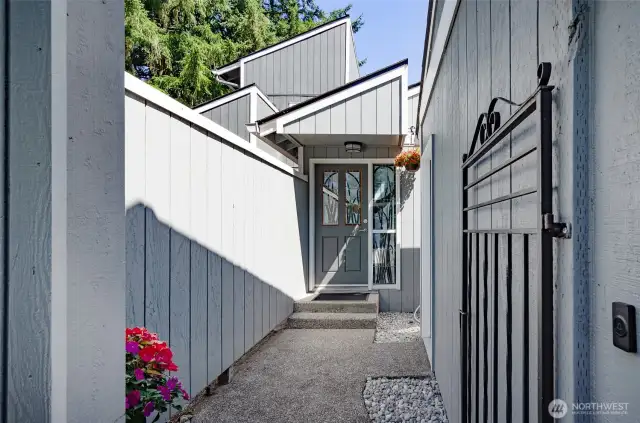 Entry to this condo.  Paved entry with detached one car garage access.   Metal gate offers a front enclosed area.