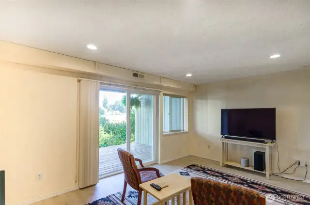 Here is the lower level family room with slider offering a deck and access to walk along the lake path.