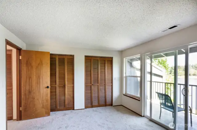 Upper level primary suite has two closets and an incredible walk out deck to view the lake from above.