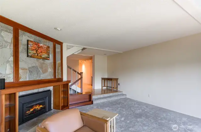 This view of the living room shows hallway entry and stairwell.