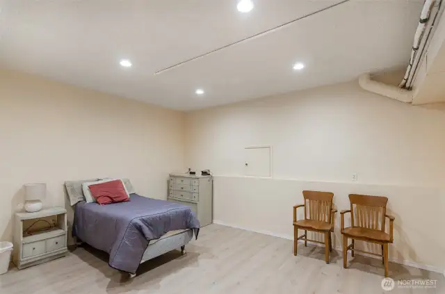 Located on the lower level, this large bonus area is  currently being used as a bedroom.