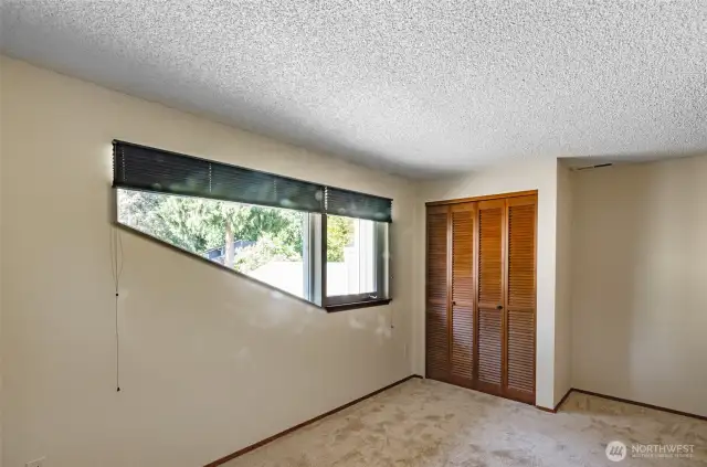 View of second bedroom on the upper level.  Custom window treatments.