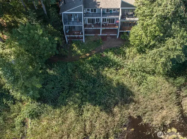 This view of the unit shows the community path along the lake.  This unit only has a couple of steps to access the trail.  How convenient.!