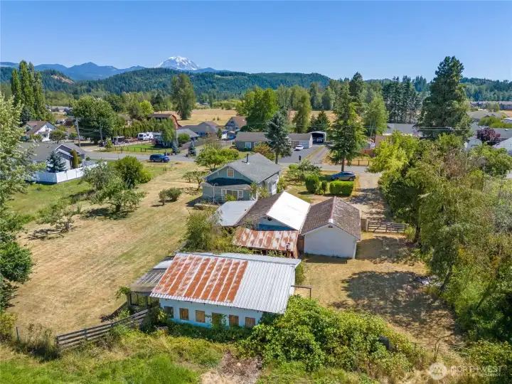 Four out buildings A barn 2garages and a green house all on shy acre. All with Mountain view.