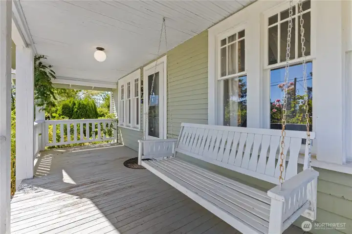 Covered front porch wirh bench swing looking at the mountain