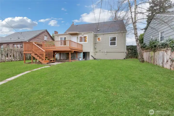 Back Yard Fully Fenced With Deck! Grass is Photoshopped.