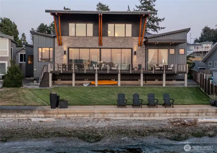 True no-bank waterfront — boat up, tie off, and step directly from the shoreline to your lawn and into the home.