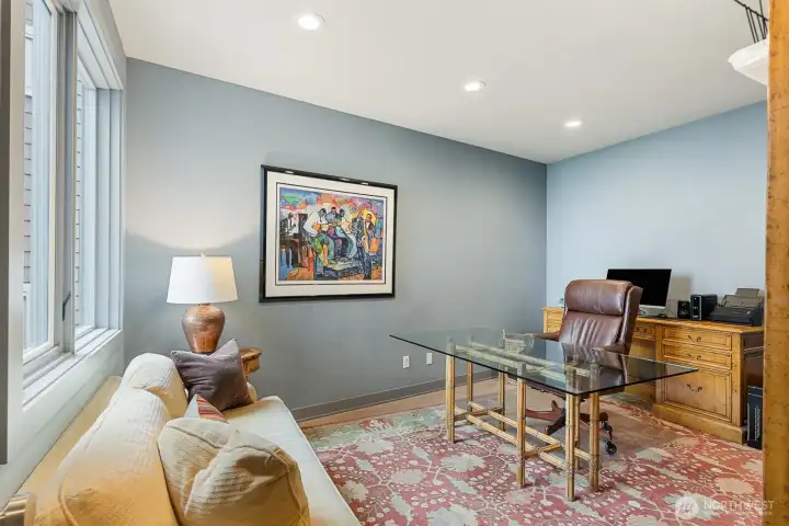 Executive office with water views, positioned on the main level and adjacent to a full bath with shower, thoughtfully designed with potential to convert into a private ADU-style suite.