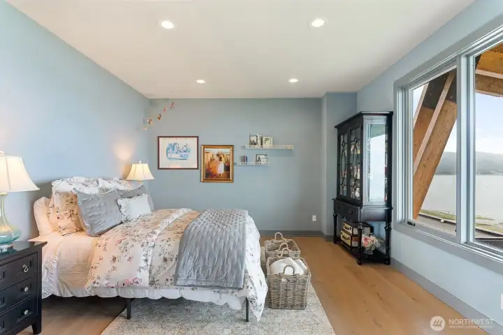 An expansive secondary bedroom with water views, ideal for bunk configurations or multiple beds, featuring a double closet perfectly suited for a shared bedroom.