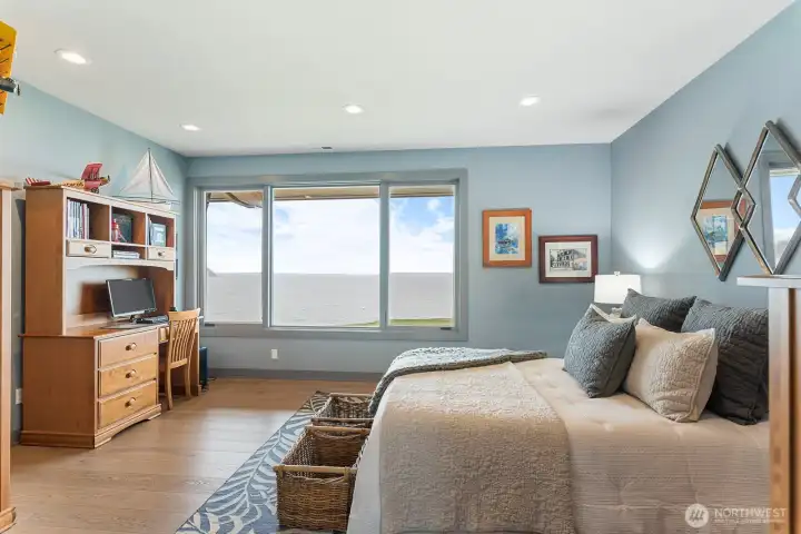 Oversized third bedroom with a large closet and stunning panoramic views stretching across the entire Sound — designed to comfortably accommodate guests while capturing the waterfront setting.