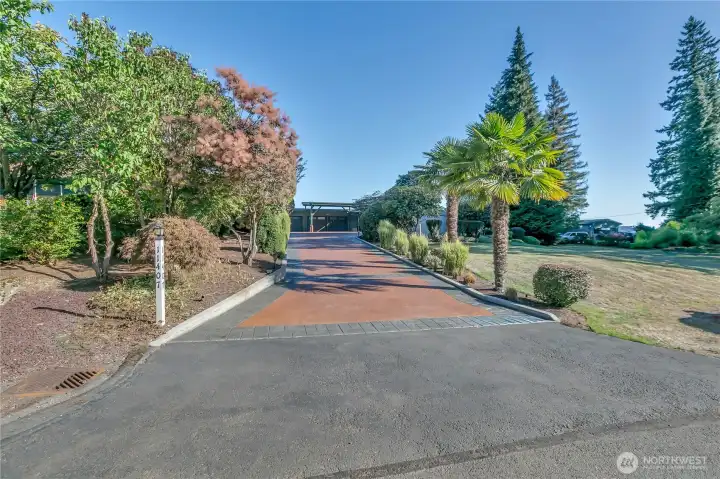 Palm trees lines and gorgeous landscaping line your entry