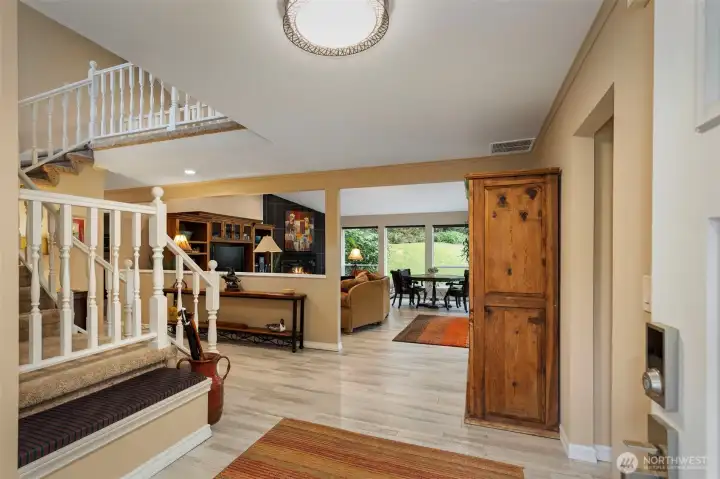 The spacious entry opens into the great room, with recently updated LVP flooring flowing across the entire main level of the home.  1/2 bath and kitchen access on the right of the entry.