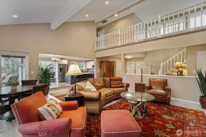 Dramatic high ceilings pull your eyes up to the open upper floor walkway, leading to two additional ensuites.