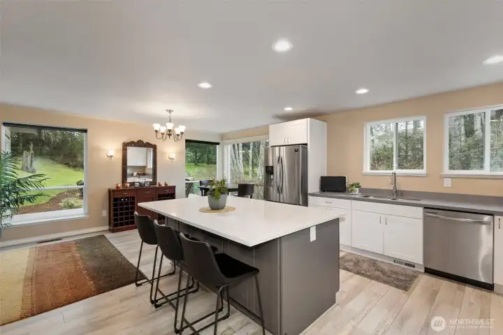 There's plenty of elbow room for everyone to hand out in this kitchen. Complementing colors of quartz counters and cabinetry provide style and functionality.