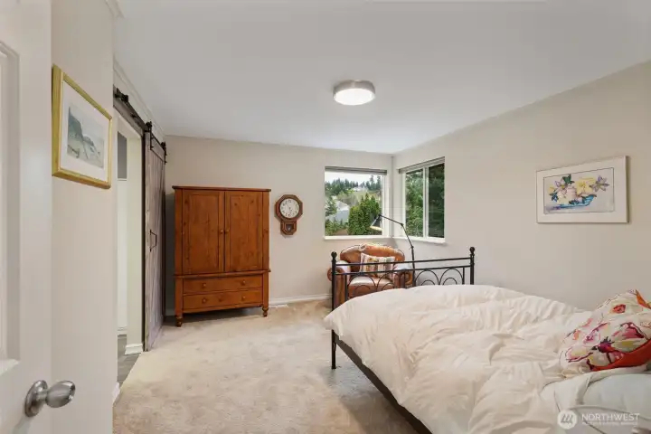 Bedroom suite number three is bright and airy and accesses it's own 3/4 bath through the stylish barn doors on the left.