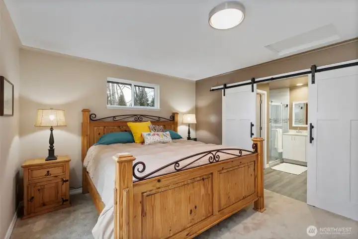 Through the charming barn doors, enter into the spacious 3/4 bath!