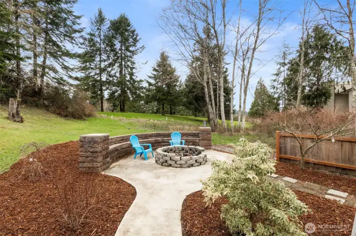 Gather around the fire pit on those chilly or not-so-chilly evenings...built-in seating along the stone wall at the edge of the patio provides room for everyone.