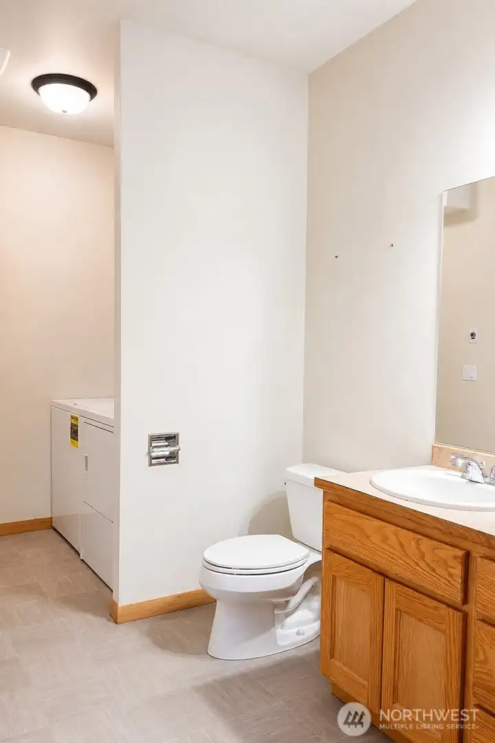 1/2 Bathroom/Laundry Room in the hallway to the Primary Bedroom 1/2 Bathroom/Laundry Room in the hallway to the Primary Bedroom