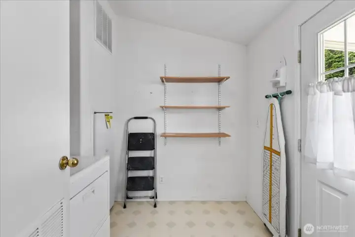 Laundry room featuring a convenient side entrance leading off the kitchen.